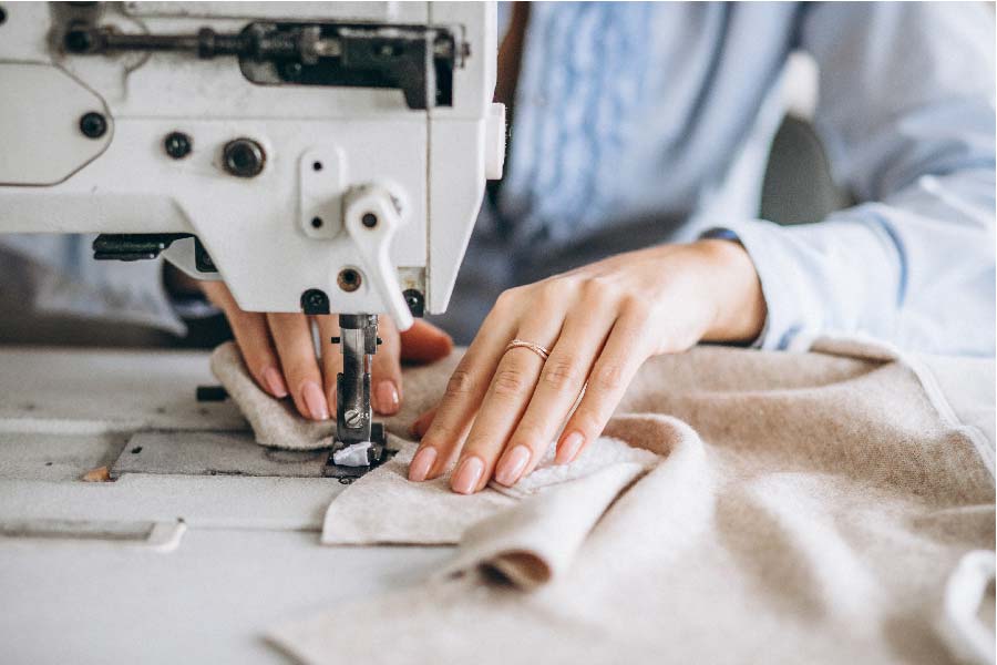 Mujer sastre durante el trabajo en patrones de costura la costurera pega  los detalles del papel para el vestido